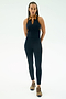 A person stands facing forward, wearing the SPLITS59 Amber Airweight High Waist 7/8 leggings in Indigo/Honey on a white background.