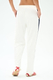 A person stands with their back to the camera, wearing SPLITS59's Maxie Rigor Track Pant - White/Indigo with a navy stripe and wide leg, paired with red-and-white sandals against a plain white background.
