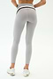 Person stands with back to camera, highlighting a sculpted look in SPLITS59 Emerson Airweight High Waist leggings in Dove Grey/Indigo and white sneakers against a plain backdrop—ideal for hot yoga or everyday wear.