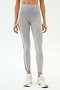 A person models SPLITS59 Emerson Airweight High Waist leggings in Dove Grey/Indigo—featuring a thin black side stripe and a sculpted fit—paired with white sneakers, perfect for hot yoga.