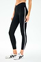 A person models the SPLITS59 Mia Rigor Legging w/ Stripe in Black/White, featuring a high waist and white side stripe, paired with white sneakers with black accents, standing against a plain white background.