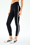 A person models the SPLITS59 Mia Rigor Legging w/ Stripe in Black/White, featuring a high waist and white side stripe, paired with white sneakers with black accents, standing against a plain white background.