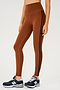 Side view of girl wearing reddish brown leggings with two thin black stripes down the side with dark blue shoes