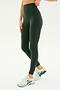 A person wearing SPLITS59's Airweight Super High Waist 7/8 leggings in Military and white running shoes stands against a plain background.