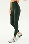 A person wearing SPLITS59's Airweight Super High Waist 7/8 leggings in Military and white running shoes stands against a plain background.