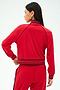 A woman in the SPLITS59 Hayes Varsity Rigor Jacket in Pirate Red.