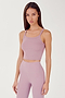 Side view of girl wearing light pink ribbed square neck cropped tank top with light pink leggings