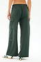Model wearing SPLITS59’s Alex Airweight Cargo Pant in Military, featuring wide legs and side pockets, paired with white slip-on shoes with green stripes; shown from the back against a plain background.