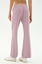 Model wears the SPLITS59 Blaire Rib Pant in Blush, showcasing the light purple flared silhouette made from soft modal-spandex, styled with white sneakers and photographed from behind against a plain backdrop.