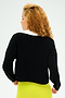 A person with curly hair is seen from behind, wearing a black Joan Fleece Polo Sweatshirt by SPLITS59 and yellow stretch modal pants.