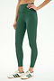 A person in SPLITS59 Airweight High Waist Legging - Arugula and white sneakers with green stripes stands against a light background—ideal for hot yoga.