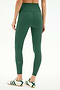 A person is seen from the back wearing SPLITS59 Airweight High Waist Legging in Arugula and white sneakers with green stripes, standing against a plain white background—ideal for hot yoga sessions.