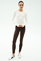 A woman stands against a white background wearing the SPLITS59 Airweight Lite Long Sleeve Waist Length tee in white—quick-drying, lightweight, and ideal for gym workouts or casual days.