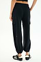 A person wears the SPLITS59 Nico Airweight Cargo Pant in black, known for its lightweight comfort, paired with black athletic shoes, standing against a plain white background.