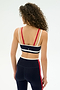 A woman with curly hair is seen from the back wearing the SPLITS59 Eva Rigor Double Strap Bra in Indigo/White—paired with high-waisted leggings, it's a stylish and comfortable choice for gym workouts that boost your confidence.
