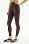 A person wearing SPLITS59 Airweight High Waist Legging in Dark Chocolate and black and white Nike sneakers stands against a plain white background.