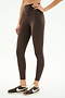 A person wearing SPLITS59 Airweight High Waist Legging in Dark Chocolate and black and white Nike sneakers stands against a plain white background.