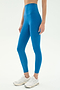 A person stands on a plain white background wearing SPLITS59 Airweight Super High Waist 7/8 leggings in Stone Blue and white athletic shoes, ideal for hot yoga.