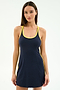 A woman stands facing forward, wearing the SPLITS59 Ella Airweight Dress in Indigo/Bright Yellow, made from a comfortable spandex blend with a racerback design.