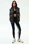 A woman faces forward wearing the SPLITS59 Summit Nylon Puffer Vest in black over a black sports bra, black leggings with a white stripe, and white sneakers—ideal for cool weather workouts against a plain background.