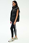 A woman stands in profile against a white background wearing the SPLITS59 Summit Nylon Puffer Vest in black, paired with black leggings featuring a white stripe and white athletic sneakers—highlighting its lightweight, cool-weather insulation for workouts.