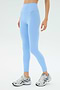 A person wearing SPLITS59 Sprint High Waist Rigor 7/8 leggings in Skylight and white running shoes stands against a plain light background.
