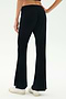 A person wearing SPLITS59 Blaire Rib Pant in black, made with soft modal and spandex, paired with white sneakers, stands on a white background, shown from the back waist down.