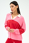 A woman stands against a plain white background wearing the SPLITS59 Katie Fleece Rugby in Strawberry/Pirate Red, a pink and red color-blocked long-sleeve top with a white collar.