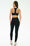 A woman with braided hair wears the SPLITS59 Airweight High Waist 7/8 Pocket Legging in black, paired with a matching sports bra, standing against a plain white background.