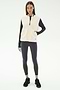 A woman wears the SPLITS59 Aster Sherpa Vest - Creme, a cozy layer for cool weather workouts, over a black long-sleeve top, leggings, and sneakers, standing against a plain white background.