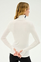 A person with long, blonde hair stands facing away, wearing a white and indigo Jackson Rib Full Length Turtleneck by SPLITS59 with thumb holes and black pants, evoking a sense of calm often found in yoga or Pilates. Their hands are clasped behind their back.