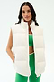 A woman models the SPLITS59 Summit Nylon Puffer Vest in white over a green sports bra and matching leggings, standing against a plain white background—ideal for lightweight insulation during cool weather workouts.