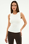 A woman stands against a plain white background wearing the SPLITS59 Carter Airweight Lite Tank in white and brown leggings crafted from a soft nylon-spandex blend.