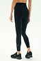 A person stands on a white background, shown from the back, wearing SPLITS59 Airweight Super High Waist 7/8 leggings in black with black athletic shoes—ideal for hot yoga sessions.