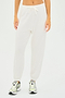Individual wearing SPLITS59 Andie Oversized Fleece Sweatpant in white and silver sneakers against a plain backdrop.