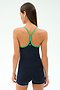 A woman with straight brown hair is seen from the back wearing the SPLITS59 Airweight Tank in Indigo/Spearmint, paired with matching shorts, both crafted from stretchy activewear fabric, against a plain background.
