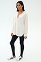 A woman stands against a white background wearing the SPLITS59 Kate Airweight Lite Button Down in white, paired with black leggings and white sneakers with black accents—an ideal lightweight layer for effortless style.