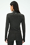 A woman facing away from the camera wears the SPLITS59 Stevie Active Rib Half Zip Waist Length top in Heather Graphite, paired with matching leggings, against a plain background.