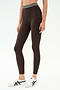 A person wears SPLITS59's Bailey High Waist Active Rib 7/8 leggings in Heather Dark Chocolate with a black-and-white striped waistband and white sneakers against a plain white background—ideal for gym sessions.