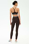 A person stands with their back to the camera, wearing the SPLITS59 Cali Active Rib Bra in Heather Dark Chocolate with matching high-waisted leggings, set against a plain white background.
