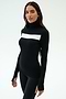 A woman wears the SPLITS59 Lennon Rib Turtleneck in Black/White, featuring a white horizontal chest stripe, standing against a plain light background—perfect for yoga or running.