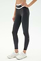 Model wearing SPLITS59 Mason High Waist Rigor Full Length leggings in Graphite/White with a white chevron waistband and white athletic shoes, standing against a plain light background.