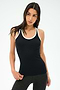 A woman with long dark hair wears the SPLITS59 Ashby Rib Tank in Black/White and dark leggings, standing against a white background, ready for her workout.