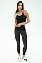 A woman faces forward wearing the SPLITS59 Ashby Rib Tank in Black/White, paired with dark gray leggings and white sneakers against a plain white background—perfect for gym workouts.