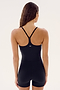 A person with long hair is wearing a black, sleeveless, form-fitting Airweight 3.5" Short Jumpsuit - Black from SPLITS59 with a racerback design, viewed from behind.