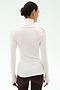 A woman with dark hair in a bun models the SPLITS59 Jackson Rib Full Length Turtleneck in White/Dark Chocolate with brown pants, shown from the back against a plain light background.
