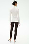 A woman stands with her back to the camera, wearing a white SPLITS59 Jackson Rib Full Length Turtleneck and dark leggings—perfect for yoga or running—paired with white athletic shoes against a plain background.