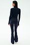 A person stands facing away against a plain white background, wearing the SPLITS59 Lennon Rib Turtleneck in Indigo/White with navy flared pants.