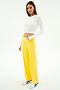 A woman stands against a white background wearing a white spandex long-sleeve crop top, SPLITS59 Willow Airweight Wide Leg pants in Bright Yellow/White, and white sneakers.