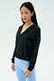 A woman wears the SPLITS59 Megan Woven Nylon Jacket in black, standing against a plain, light background.